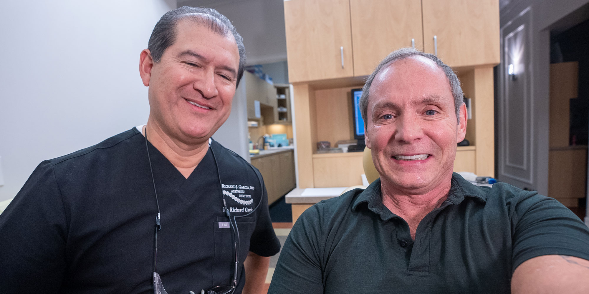 patient and doctor smiling both after patient's dental treatment