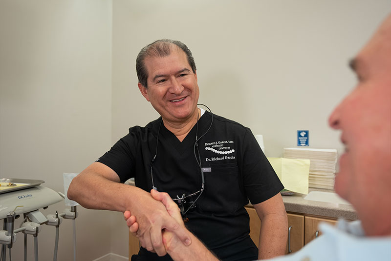 doctor shaking hands with dental patient