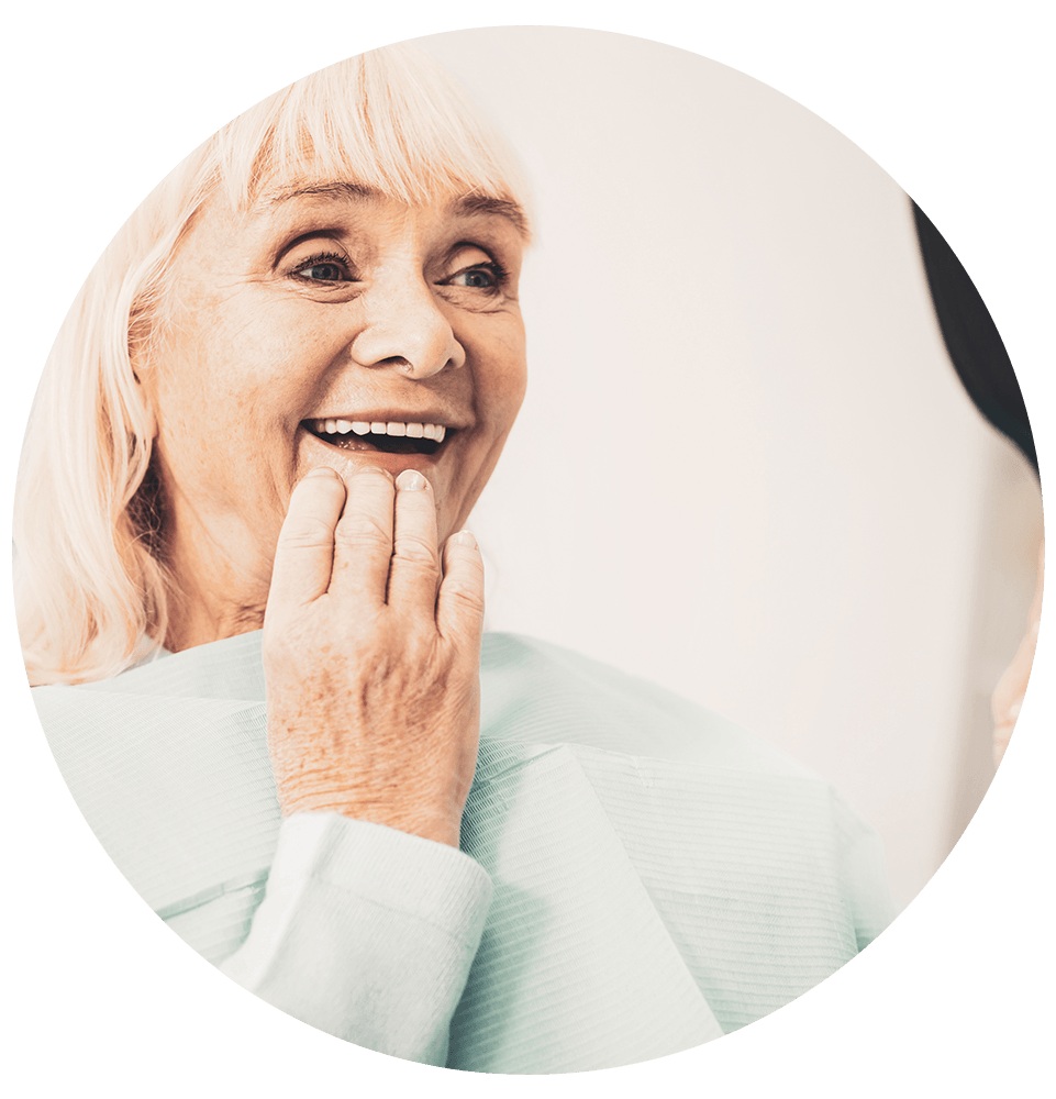 mature women smiling after having their denture treatment