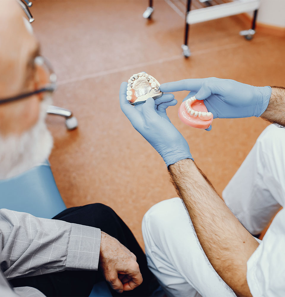 dental patient going over with doctor denture replacement options