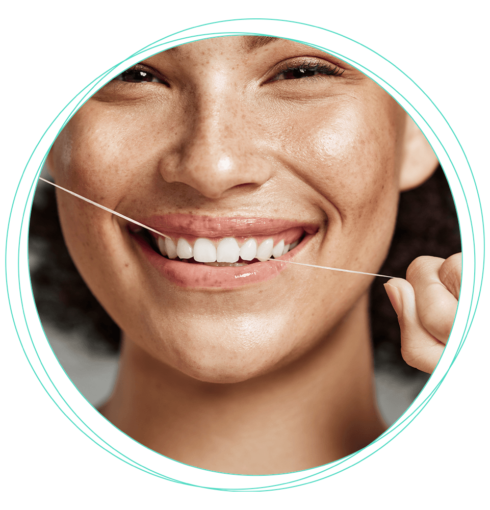 close up of person flossing their teeth and smiling