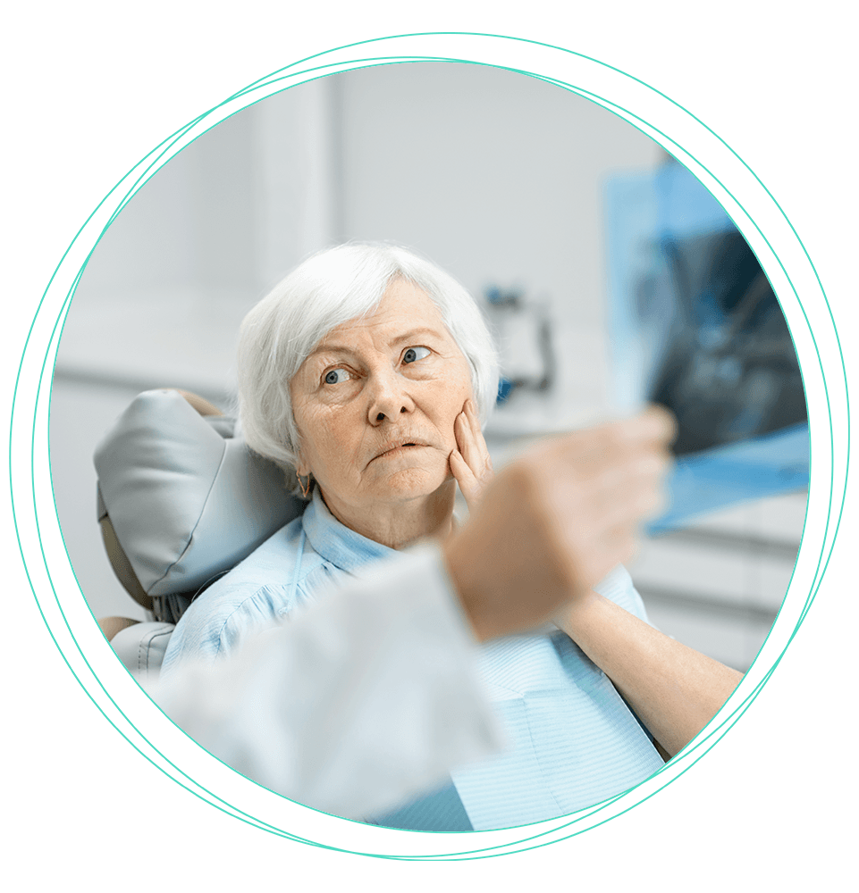 mature patient listening to doctor while experiencing mouth pain