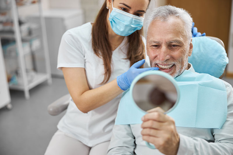 patient smiling. brightly after their dental procedure