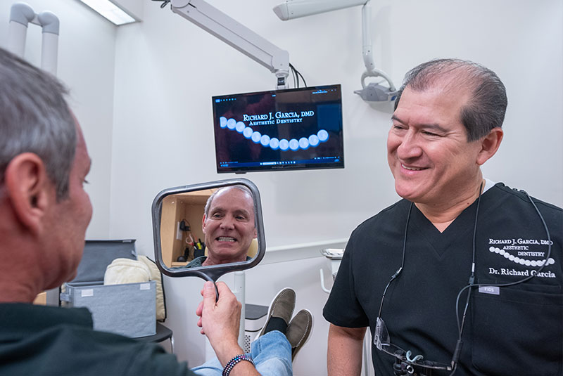 patient and doctor both smiling after patient's dental treatment