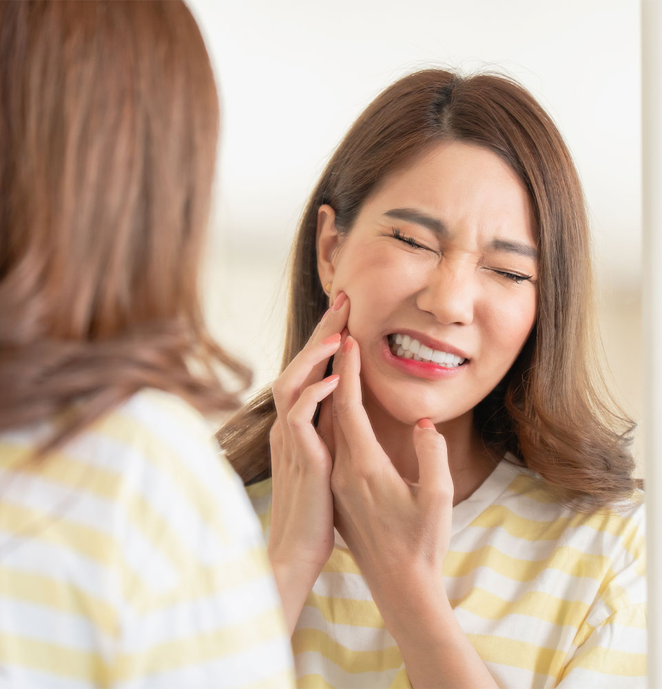 female having mouth pain in their own home