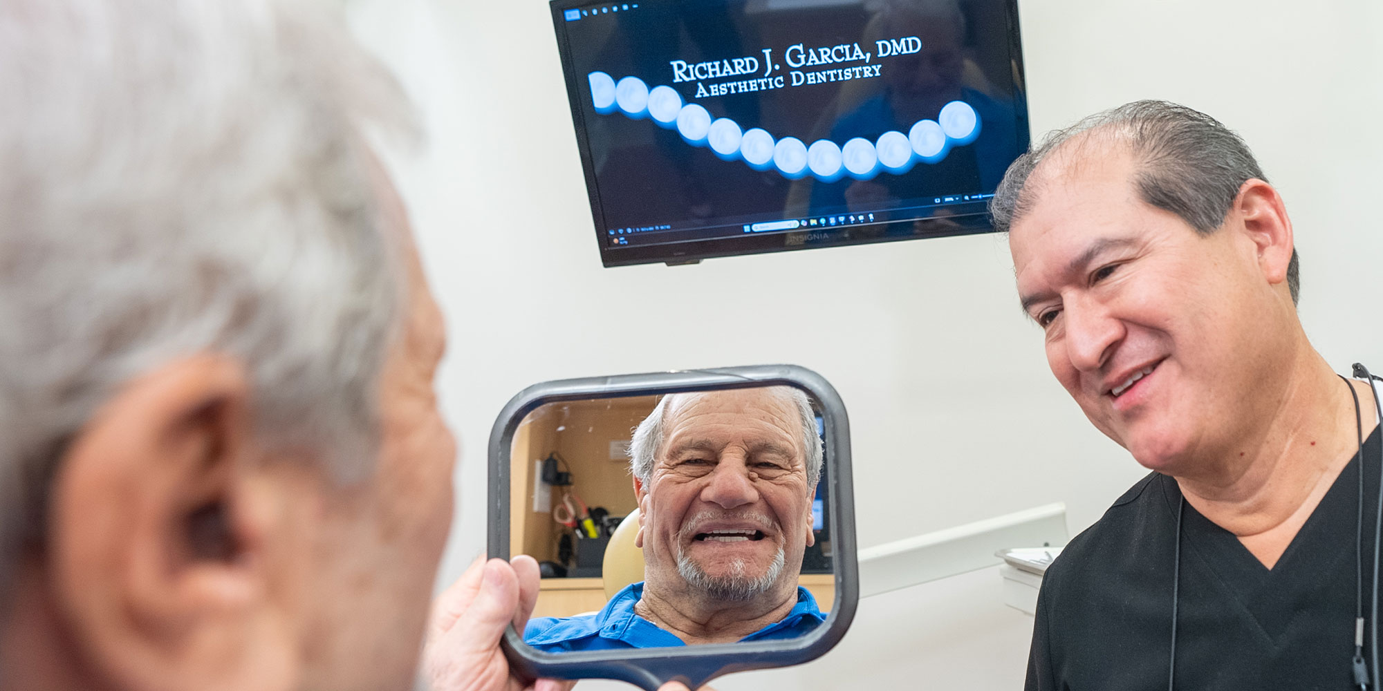 patient and doctor both smiling after patient's dental treatment