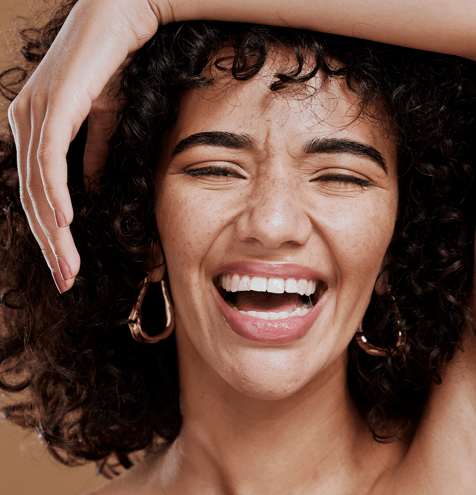 headshot of beautiful model smiling brightly